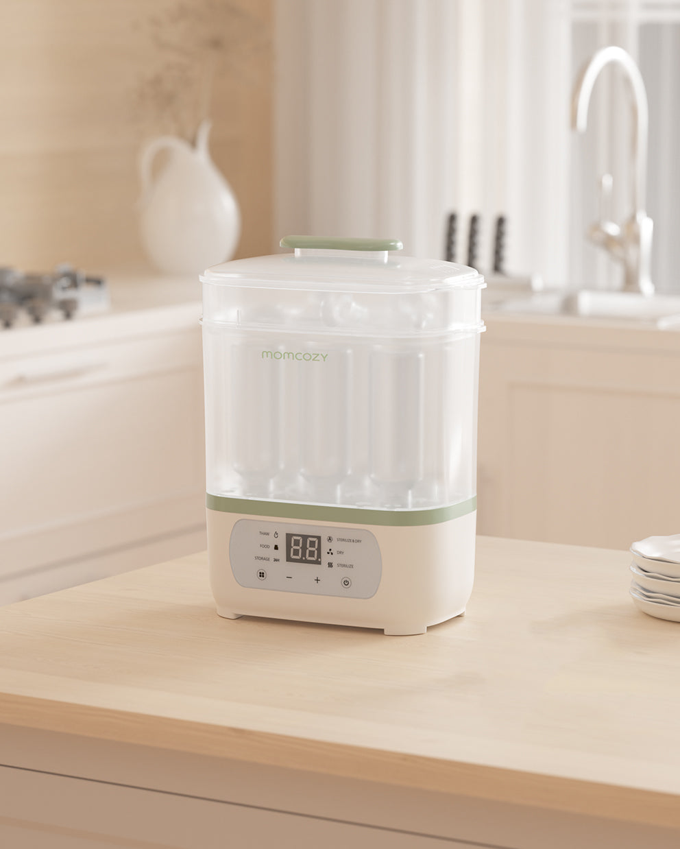 Momcozy 8-in-1 Baby Bottle Steam Sterilizer with LED countdown display on a light wooden kitchen countertop